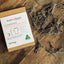 That red house australian made marine grade rust proof stainless steel pegs front of packaging with scattered pegs on wooden table