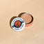 Sunbutter Surf Zinc sunscreen open tin on a beige background