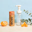 Ecyo foaming hand wash bottle and refill container with oranges and eucalyptus on a light blue background