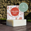 Dishwashing block with packaging on a wooden surface, featuring a 'Clean & Conscious Awards' finalist badge.