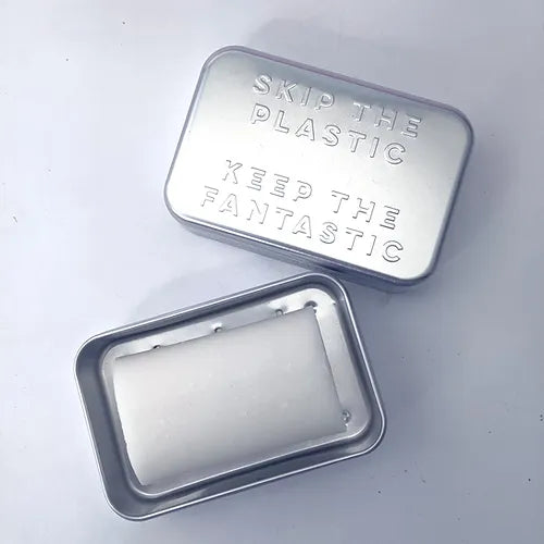 Shampoo with a purpose aluminium travel soap tin with removable tray for drainage shown with soap