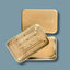 Aluminium travel soap tin with 'INDISPOSABLE' logo on a blue background
